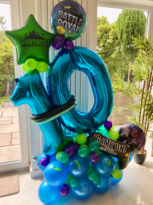 Fortnite balloons Manchester, with large foil number 10 and assorted balloon in blue and green.