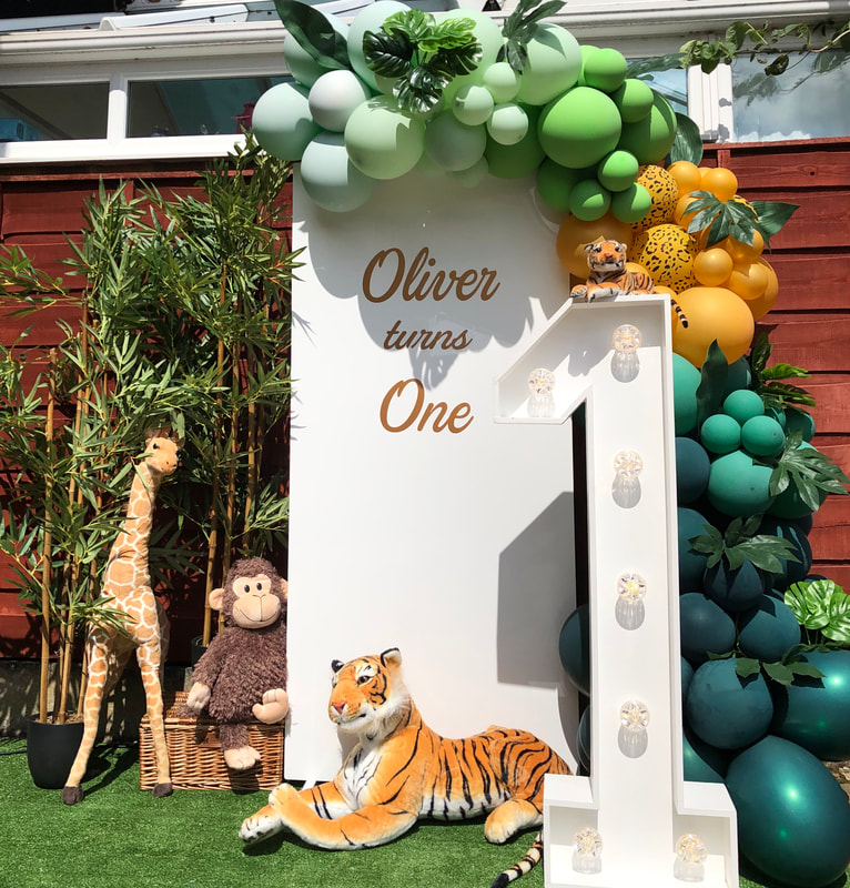 1st birthday safari party in Cheshire with personalised backdrop, 4ft LED number 1 and balloon garland. 