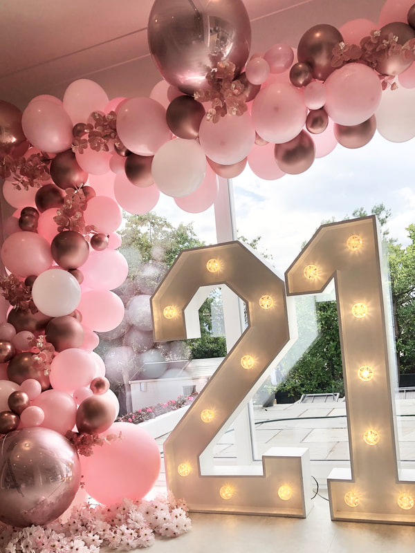 21st Birthday decoration in Cheshire with 4ft LED numbers nd deluxe balloon garland d in pink and rose gold with flowers.