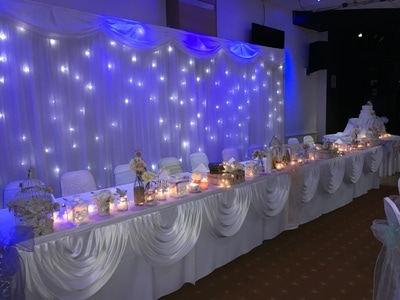 Wedding top table in Manchester with starlight backdrop.